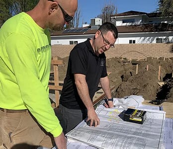 service design build two men looking at blueprints